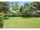 Lush green backyard with well-maintained lawn and privacy hedges, perfect for outdoor enjoyment at 600 Northern Way # 607, Winter Springs, FL 32708