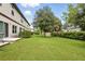 Well-maintained backyard featuring lush lawn, patio, and mature trees, creating a tranquil outdoor setting at 600 Northern Way # 607, Winter Springs, FL 32708