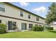 Spacious backyard with lush green grass, patio, and hedges, perfect for outdoor living and entertaining at 600 Northern Way # 607, Winter Springs, FL 32708