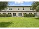Expansive backyard with a lush lawn, patio area, and privacy hedges creating a serene outdoor space at 600 Northern Way # 607, Winter Springs, FL 32708