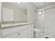 Bright bathroom featuring granite countertop, white cabinets, and glass-enclosed shower at 600 Northern Way # 607, Winter Springs, FL 32708