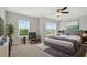 Comfortable bedroom with natural light, plush carpeting, neutral walls, and ceiling fan at 600 Northern Way # 607, Winter Springs, FL 32708