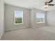 Spacious bedroom with large windows, carpet flooring, neutral walls, and a ceiling fan at 600 Northern Way # 607, Winter Springs, FL 32708