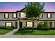 Inviting townhome exterior features well-manicured lawn and a charming tree in the front yard at 600 Northern Way # 607, Winter Springs, FL 32708