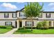 Inviting townhome exterior features well-manicured lawn and a charming tree in the front yard at 600 Northern Way # 607, Winter Springs, FL 32708