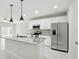 Open concept kitchen with stainless steel appliances and a center island at 600 Northern Way # 607, Winter Springs, FL 32708