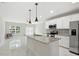 Modern kitchen with island, stainless steel appliances, and bright white cabinetry at 600 Northern Way # 607, Winter Springs, FL 32708