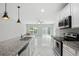 Open kitchen features granite counters, stainless steel appliances, white cabinets, and marble floors at 600 Northern Way # 607, Winter Springs, FL 32708