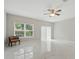 Open living room with bright marble floors, a ceiling fan, and sliding glass doors to the outside at 600 Northern Way # 607, Winter Springs, FL 32708