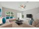 Living room with a neutral color palette, plush rug, large windows, and ceiling fan at 600 Northern Way # 607, Winter Springs, FL 32708