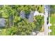 Birds eye view of a house showcasing driveway, mature trees and landscaping on a large lot at 706 19Th St, Orlando, FL 32805
