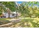 Wide backyard view with trees and the building at the rear at 706 19Th St, Orlando, FL 32805