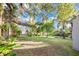 Large backyard with mature trees offers shade and privacy, ideal for outdoor activities at 706 19Th St, Orlando, FL 32805
