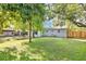 Backyard with green grass and mature trees at 706 19Th St, Orlando, FL 32805