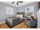 Comfortable bedroom with light blue walls, wood-look floors, and a cozy chair next to the bed at 706 19Th St, Orlando, FL 32805