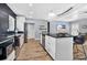 Bright kitchen features white cabinets, black countertops, stainless steel appliances, and wood-look floors at 706 19Th St, Orlando, FL 32805