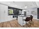 Modern kitchen features sleek cabinets, stainless steel appliances, and an island with seating at 706 19Th St, Orlando, FL 32805