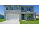 Charming two-story home with a two car garage and a well-maintained front yard at 766 Mocking Jay Ln, St Cloud, FL 34771