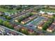 Aerial view of a well-planned community with townhomes, lush landscaping, and a tranquil pond at 814 Calabria Ave, Davenport, FL 33897