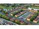 Aerial view of a well-planned community with townhomes, lush landscaping, and a tranquil pond at 814 Calabria Ave, Davenport, FL 33897