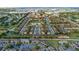 A picturesque aerial view shows an attractive community with a central pond and lush greenery at 814 Calabria Ave, Davenport, FL 33897