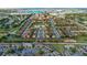 Beautiful aerial view of a community with townhomes, a pond, and a clubhouse in the background at 814 Calabria Ave, Davenport, FL 33897