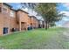 Spacious backyard with lush green grass and modern townhomes, perfect for outdoor enjoyment at 814 Calabria Ave, Davenport, FL 33897
