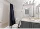 Functional bathroom includes a shower with a curtain, toilet, and a vanity with storage at 814 Calabria Ave, Davenport, FL 33897