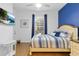 Bright bedroom with a queen bed, accent wall and natural light from the window at 814 Calabria Ave, Davenport, FL 33897