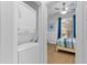 This bedroom view includes a stacked washer and dryer with the main bedroom visible behind it at 814 Calabria Ave, Davenport, FL 33897