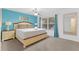Large main bedroom features a king bed, side tables, artwork, and natural light at 814 Calabria Ave, Davenport, FL 33897