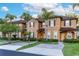 Townhome featuring a two-story facade, tropical landscaping and inviting curb appeal at 814 Calabria Ave, Davenport, FL 33897