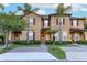 Inviting two-story townhome with manicured landscaping, a brick pathway, and a charming front entrance at 814 Calabria Ave, Davenport, FL 33897