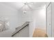 Hallway features include a chandelier, stairway and railing, and a bedroom door at 814 Calabria Ave, Davenport, FL 33897