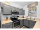 Functional kitchen includes gray cabinets, stainless steel appliances, and plenty of counter space at 814 Calabria Ave, Davenport, FL 33897