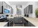 Well-lit kitchen features gray cabinets, modern appliances, and a window offering natural light at 814 Calabria Ave, Davenport, FL 33897