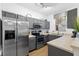 Efficient kitchen with stainless steel appliances, grey cabinetry, and ample countertop space at 814 Calabria Ave, Davenport, FL 33897