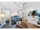 Open-concept living room with a dining area, staircase, and entertainment center at 814 Calabria Ave, Davenport, FL 33897