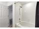 Bright and clean shower area with white tiling and a modern shower head for a refreshing experience at 814 Calabria Ave, Davenport, FL 33897