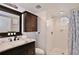 Bathroom features a stylish vanity with cabinet, a toilet and walk-in shower with octagon window at 8709 Knightsbridge Ct # B, Kissimmee, FL 34747