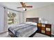 Bedroom with large window, ceiling fan, colorful dresser, bed and view to the outside yard at 8709 Knightsbridge Ct # B, Kissimmee, FL 34747