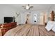 Comfortable bedroom features a ceiling fan, a dresser with TV, a walk-in closet and ensuite bathroom at 8709 Knightsbridge Ct # B, Kissimmee, FL 34747