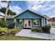 Charming blue clubhouse with white trim, inviting entrance, and well-maintained landscaping at 8709 Knightsbridge Ct # B, Kissimmee, FL 34747