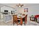 Well-lit kitchen area with stainless steel appliances, white cabinets, dining table and tile backsplash at 8709 Knightsbridge Ct # B, Kissimmee, FL 34747