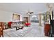 Open-concept living room with neutral tones, comfortable seating, dining table and large window at 8709 Knightsbridge Ct # B, Kissimmee, FL 34747