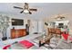 Inviting living room features a decorative fireplace, grey sofa, dining table and ceiling fan at 8709 Knightsbridge Ct # B, Kissimmee, FL 34747