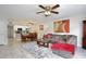 Spacious living room with a comfortable grey sofa, dining table, kitchen and modern décor at 8709 Knightsbridge Ct # B, Kissimmee, FL 34747