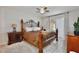 Main bedroom features a decorative bed frame, tile floor, and a sliding glass door to a balcony at 8709 Knightsbridge Ct # B, Kissimmee, FL 34747