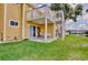 Outdoor patio area with seating, with a lawn, and view to a nearby pond with fountain at 8709 Knightsbridge Ct # B, Kissimmee, FL 34747