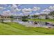 Scenic view of the community pond, with surrounding lawn and residences under cloudy skies at 8709 Knightsbridge Ct # B, Kissimmee, FL 34747